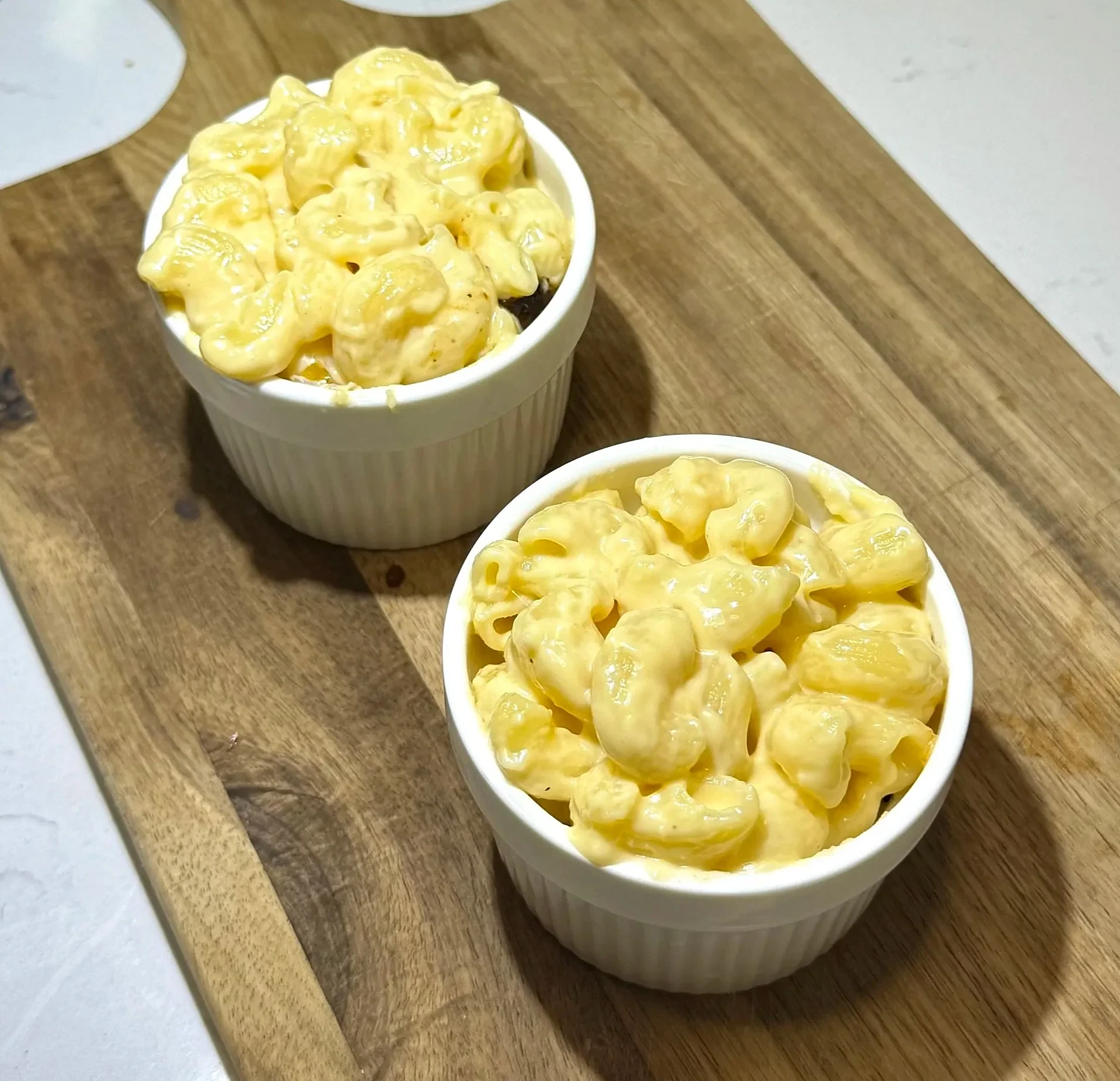 Top with creamy mac and cheese, making sure to fully cover the oxtail layer.