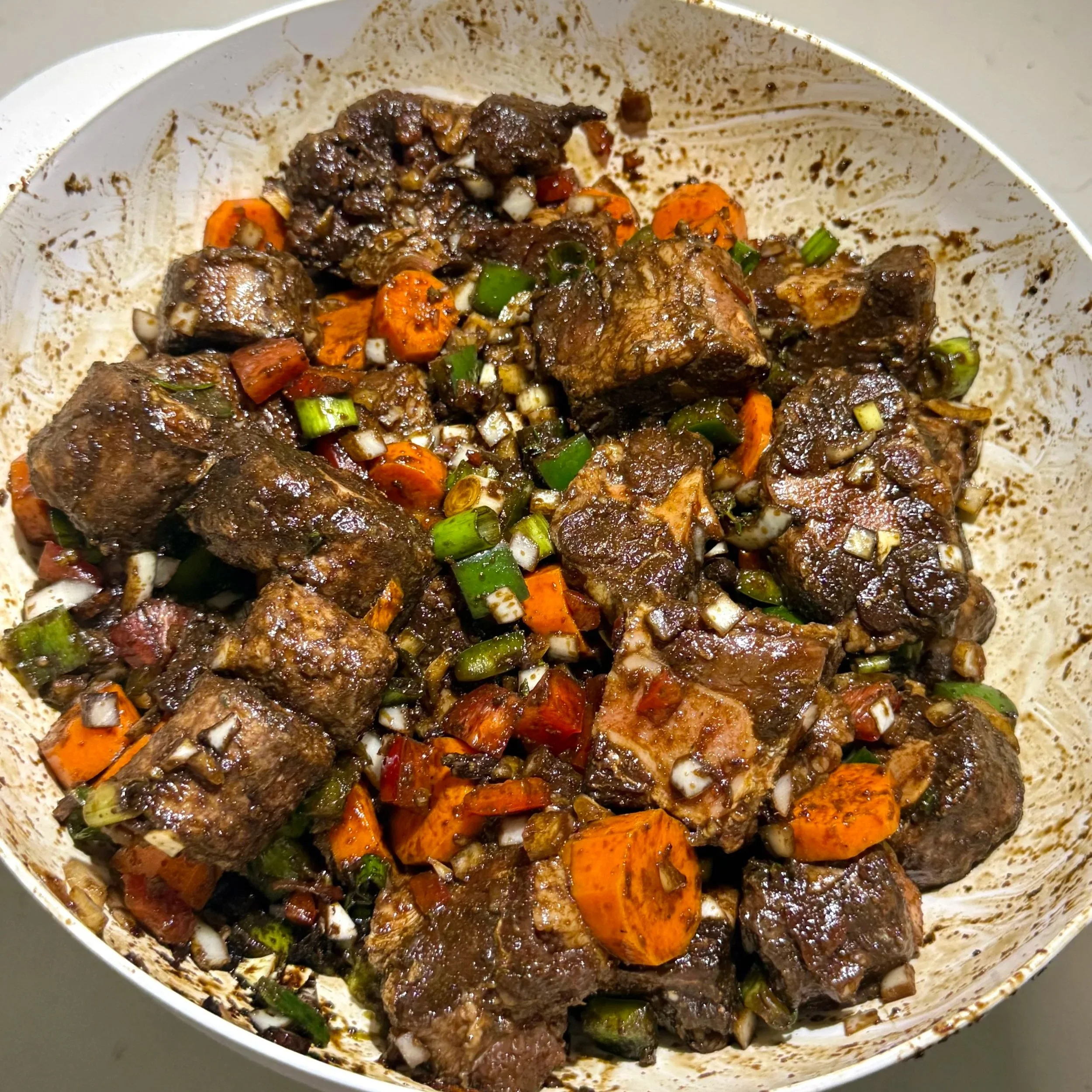 Let the oxtail marinate with fresh herbs, spices, and vegetables for deep, rich flavor.