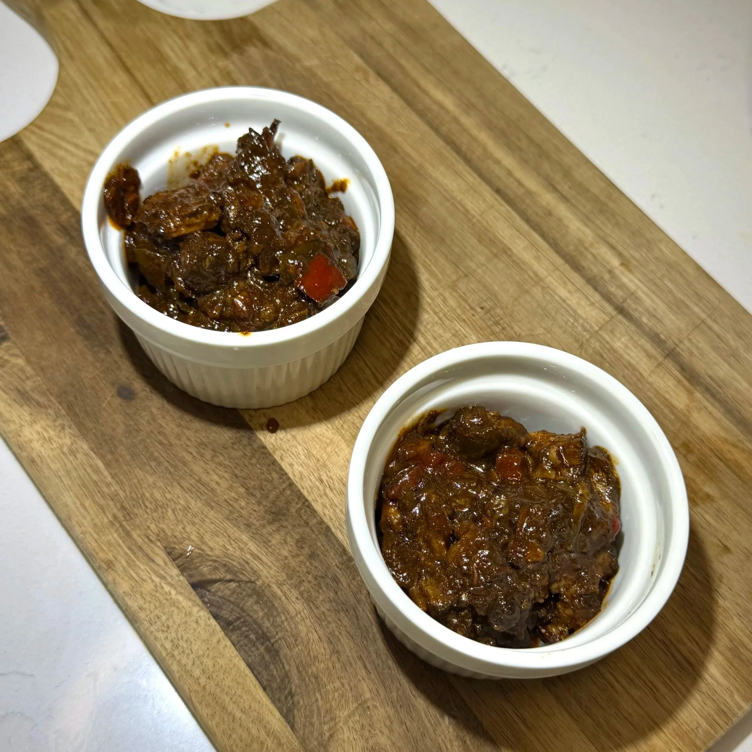 Start layering by adding the rich oxtail and gravy to the bottom of your dish.