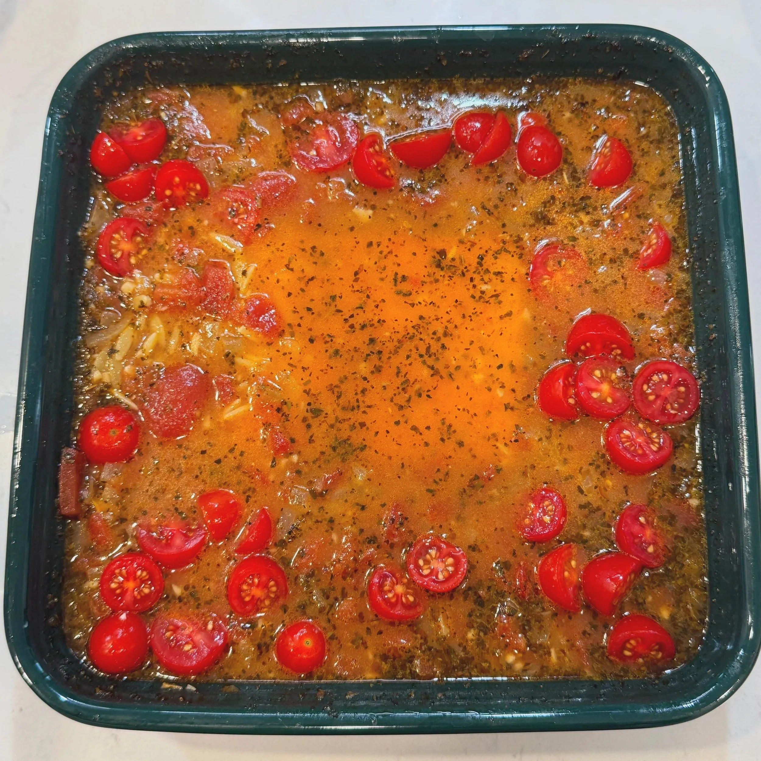 Feta block and fresh tomatoes added midway through baking..