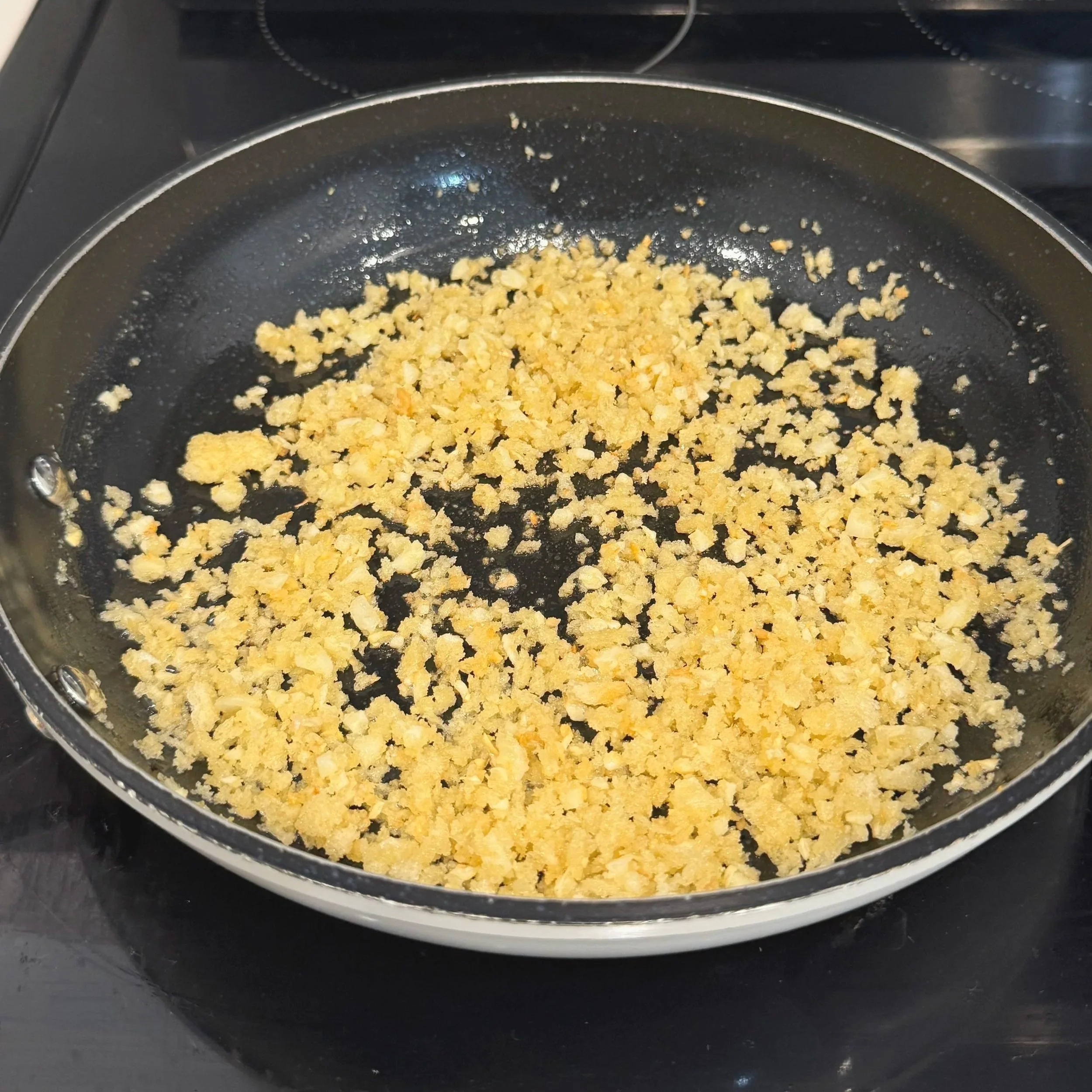 Crispy garlic-panko topping toasting until golden.