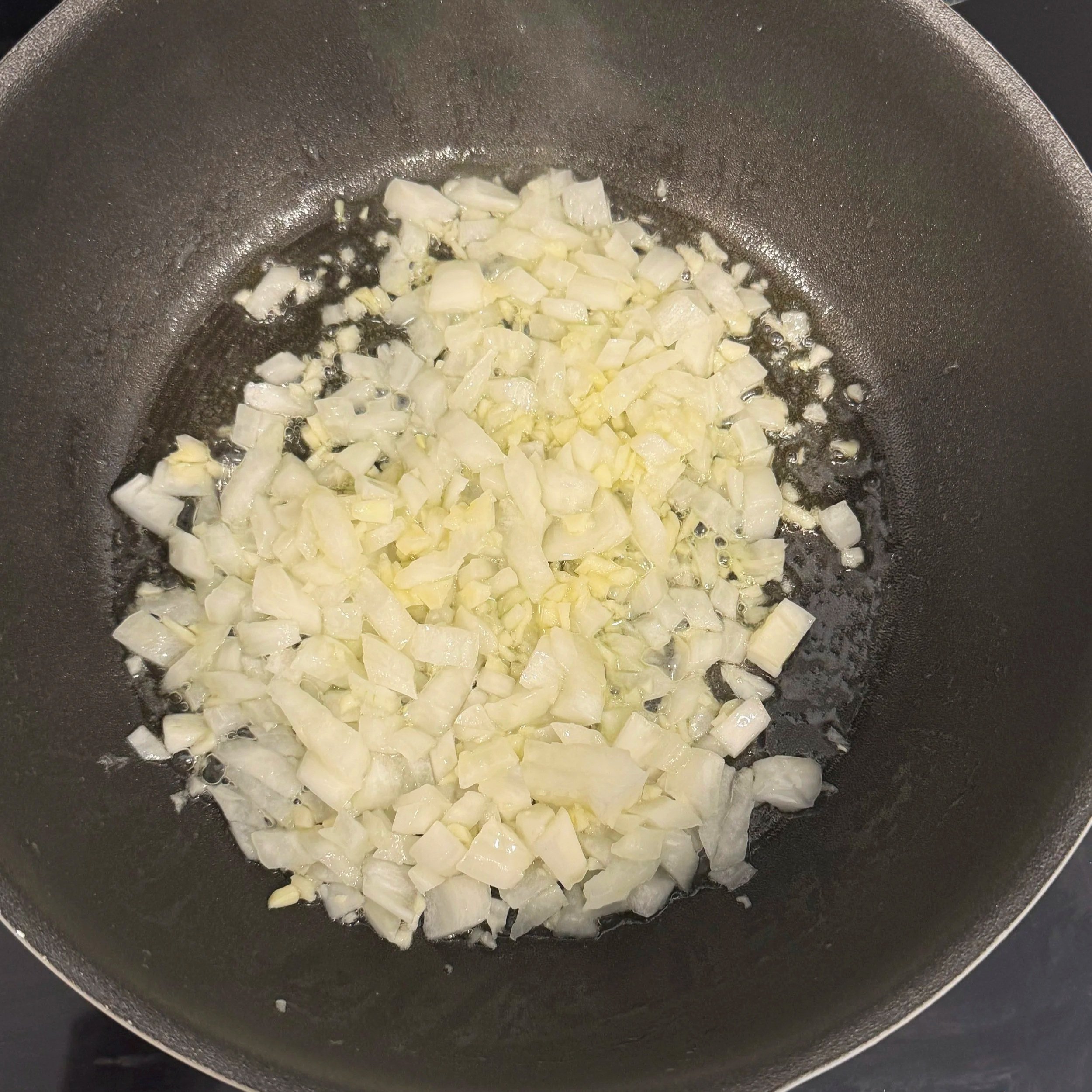 Building the flavor base — onion and garlic sauteed until fragrant.