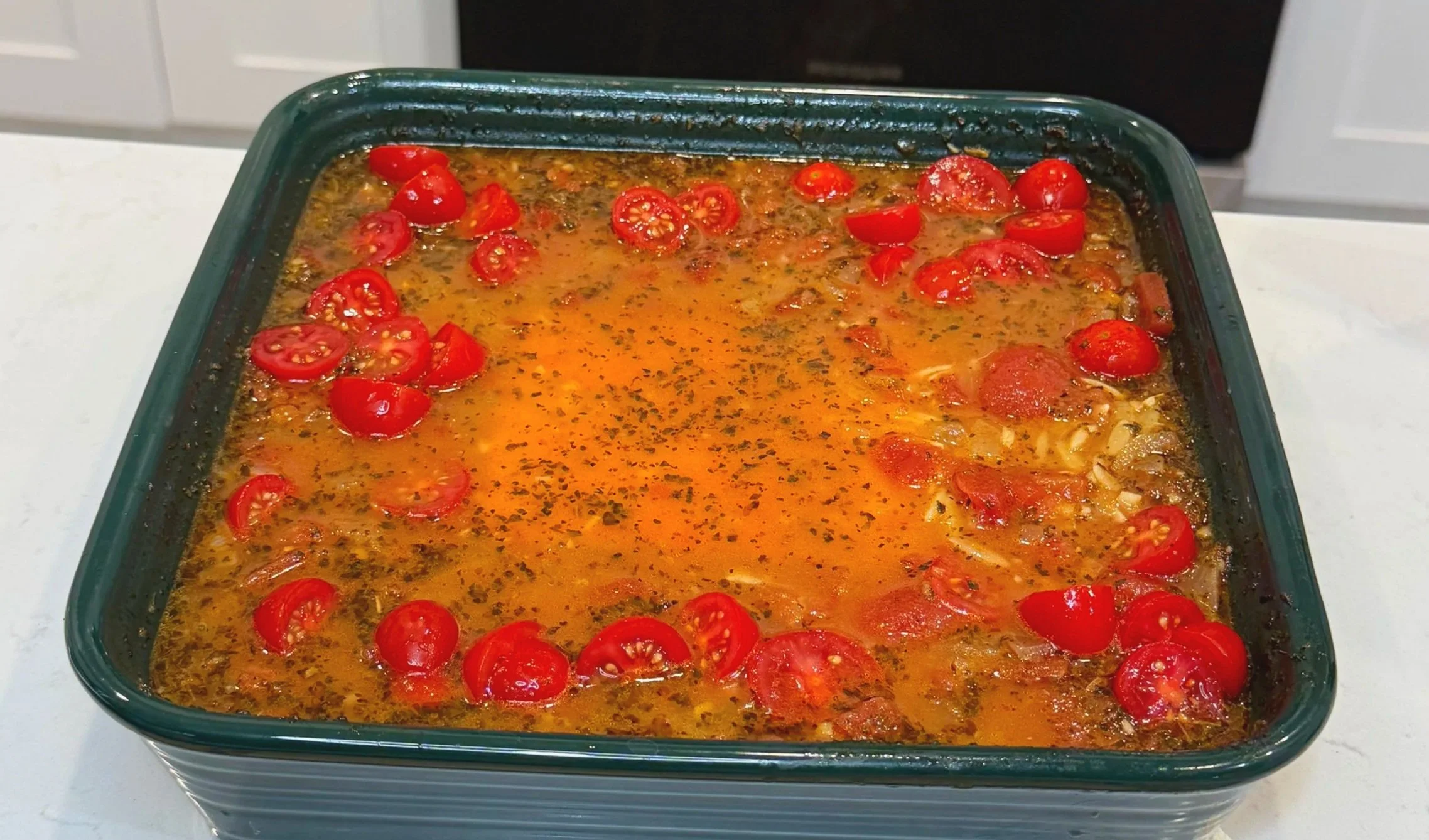 Orzo stirred into the tomato base before baking.