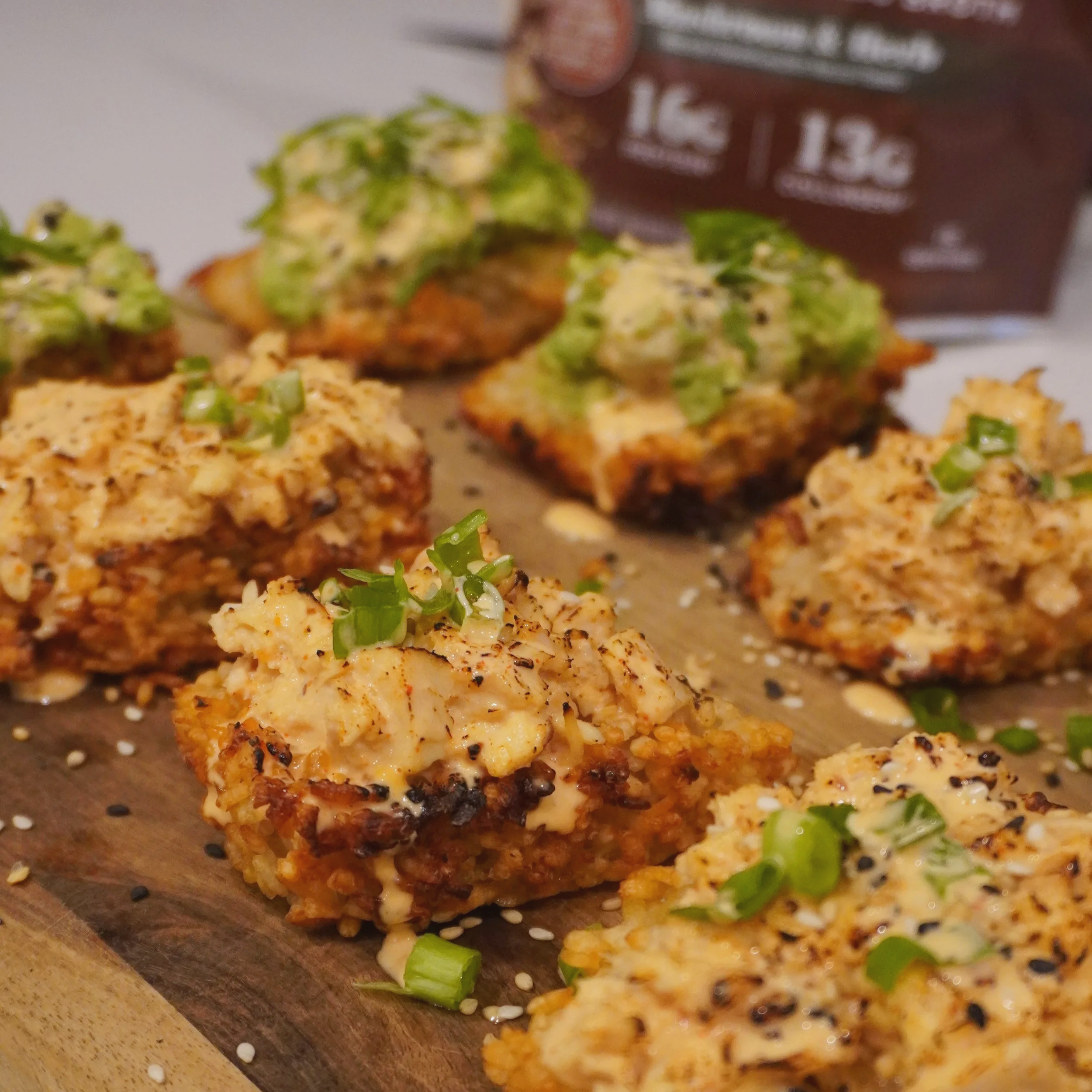 Close-up hero shot of the finished rice bites, golden and crispy with glossy toppings