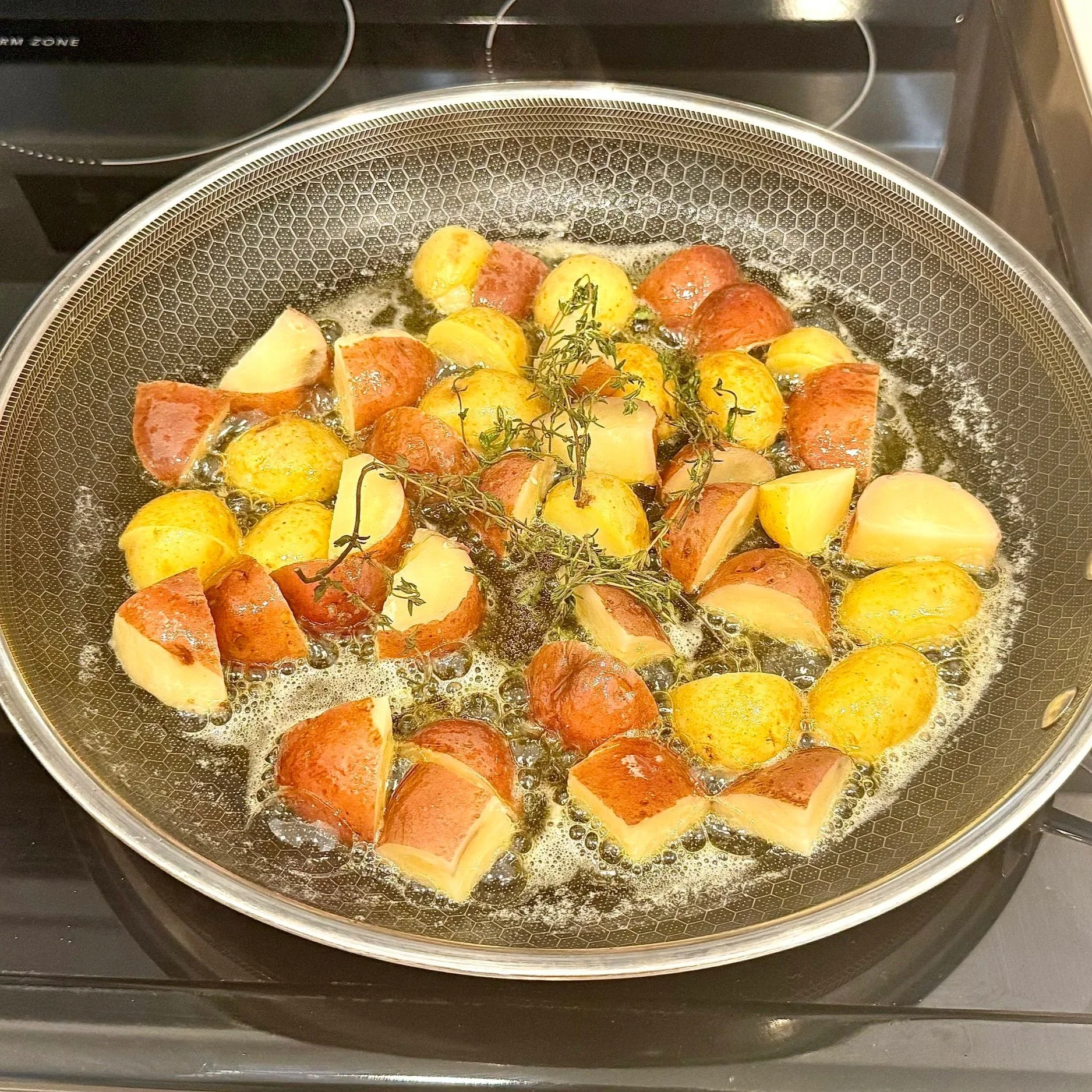  Crisp the potatoes in butter and thyme until golden and crackling. 