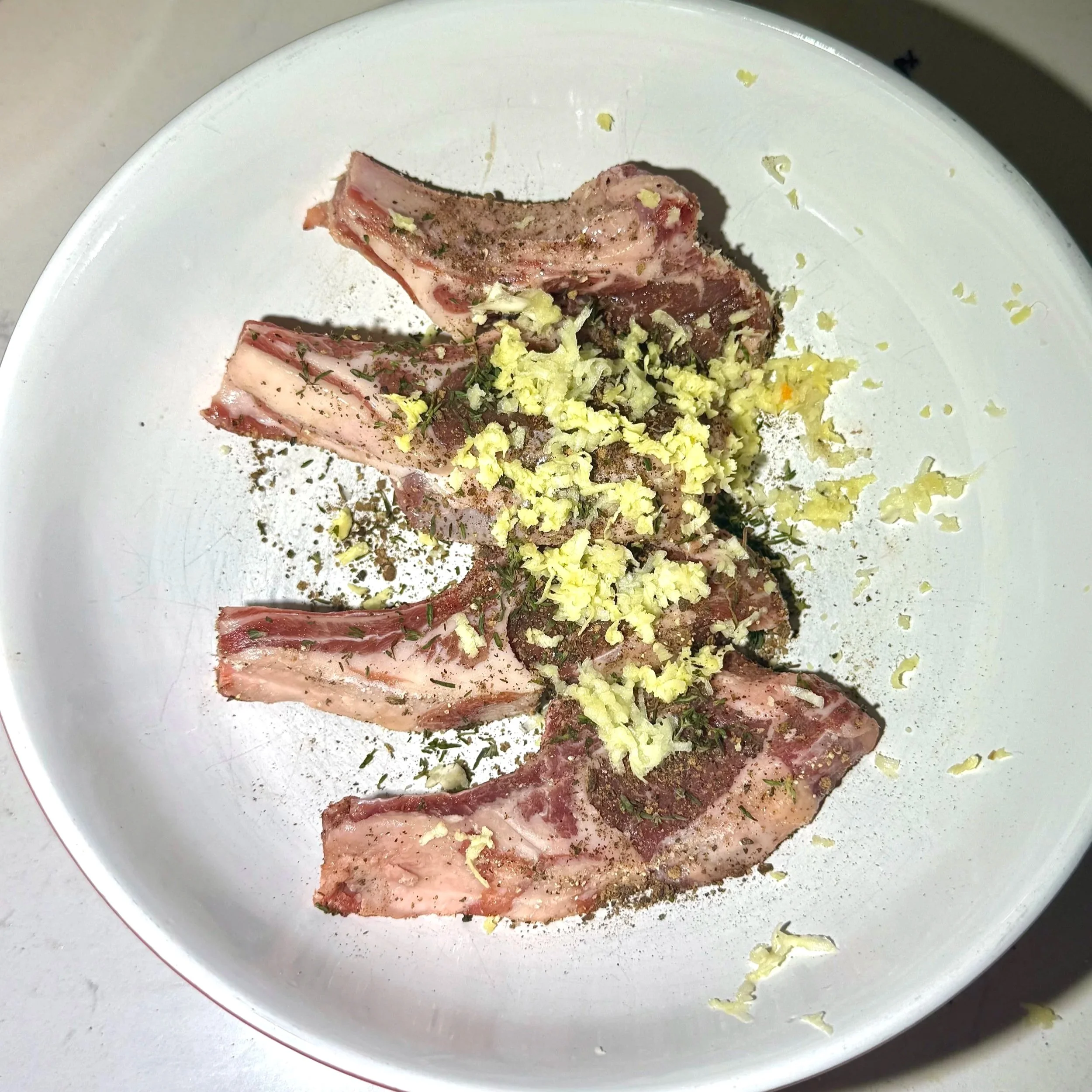  Seasoning the lamb chops with Jamaican aromatics for maximum flavor. 
