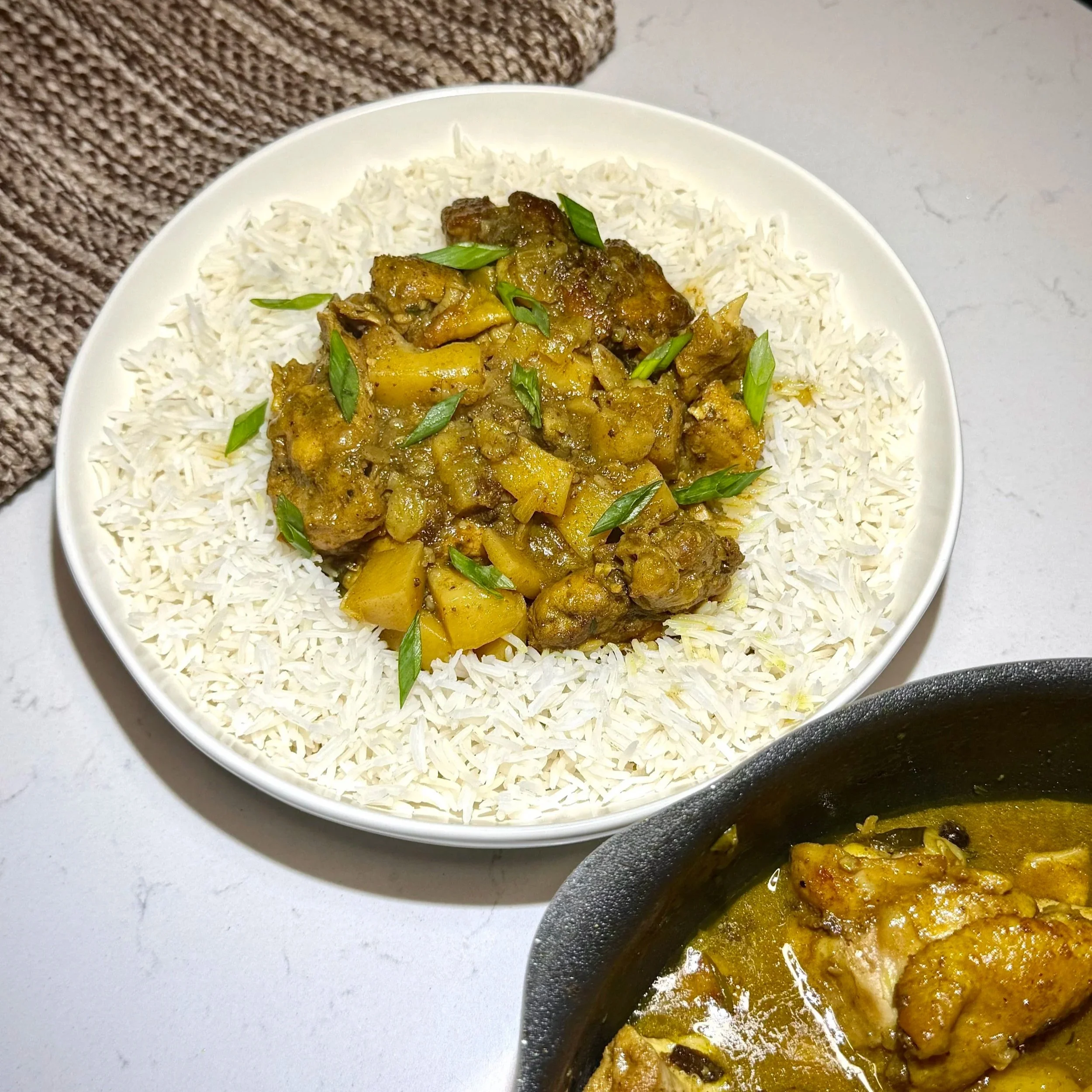   Authentic Jamaican Curry Chicken — tender bone‑in chicken simmered in golden curry gravy with potatoes and thyme, served over fluffy white rice.  