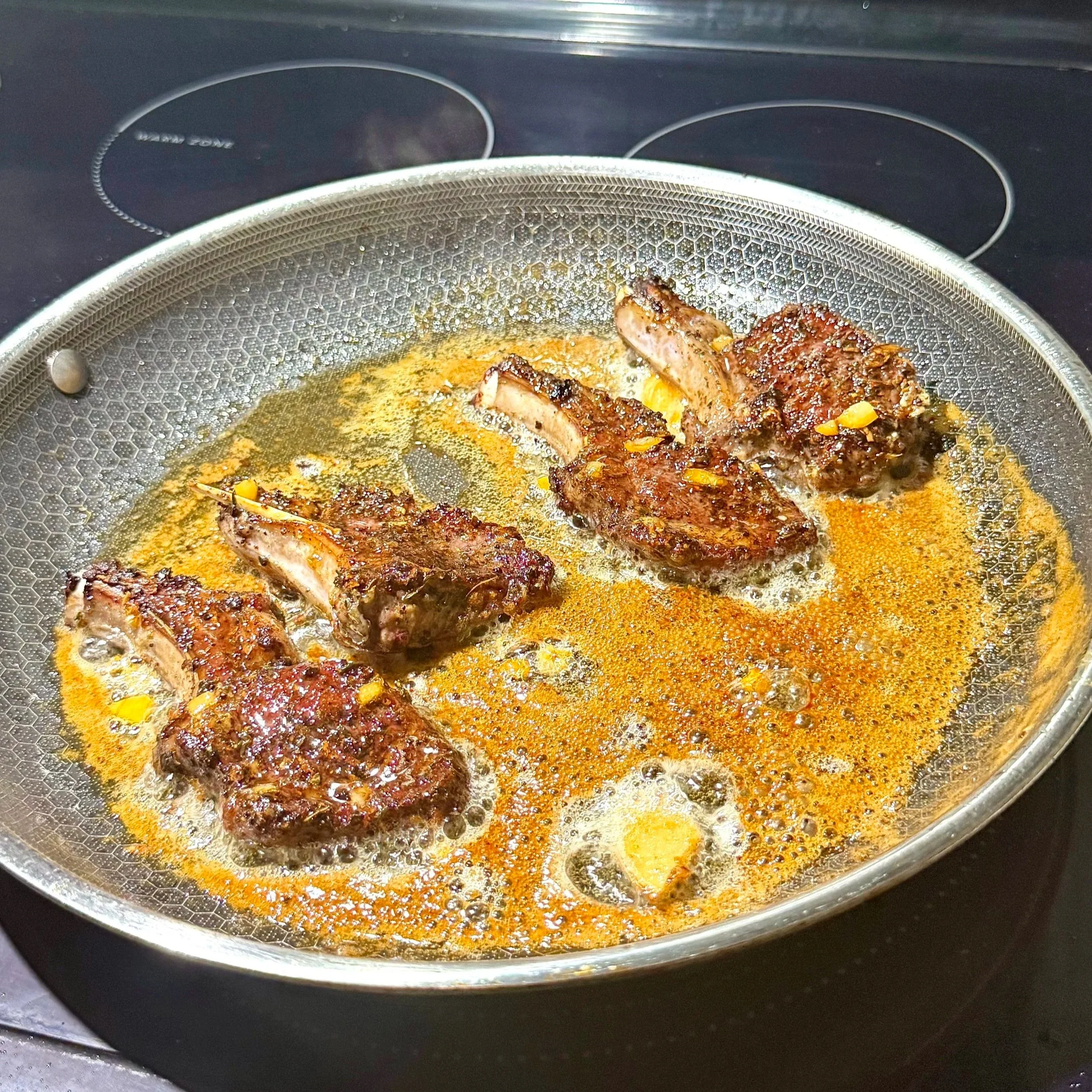  Basting the lamb chops with honey‑butter for a glossy sweet‑heat finish. 
