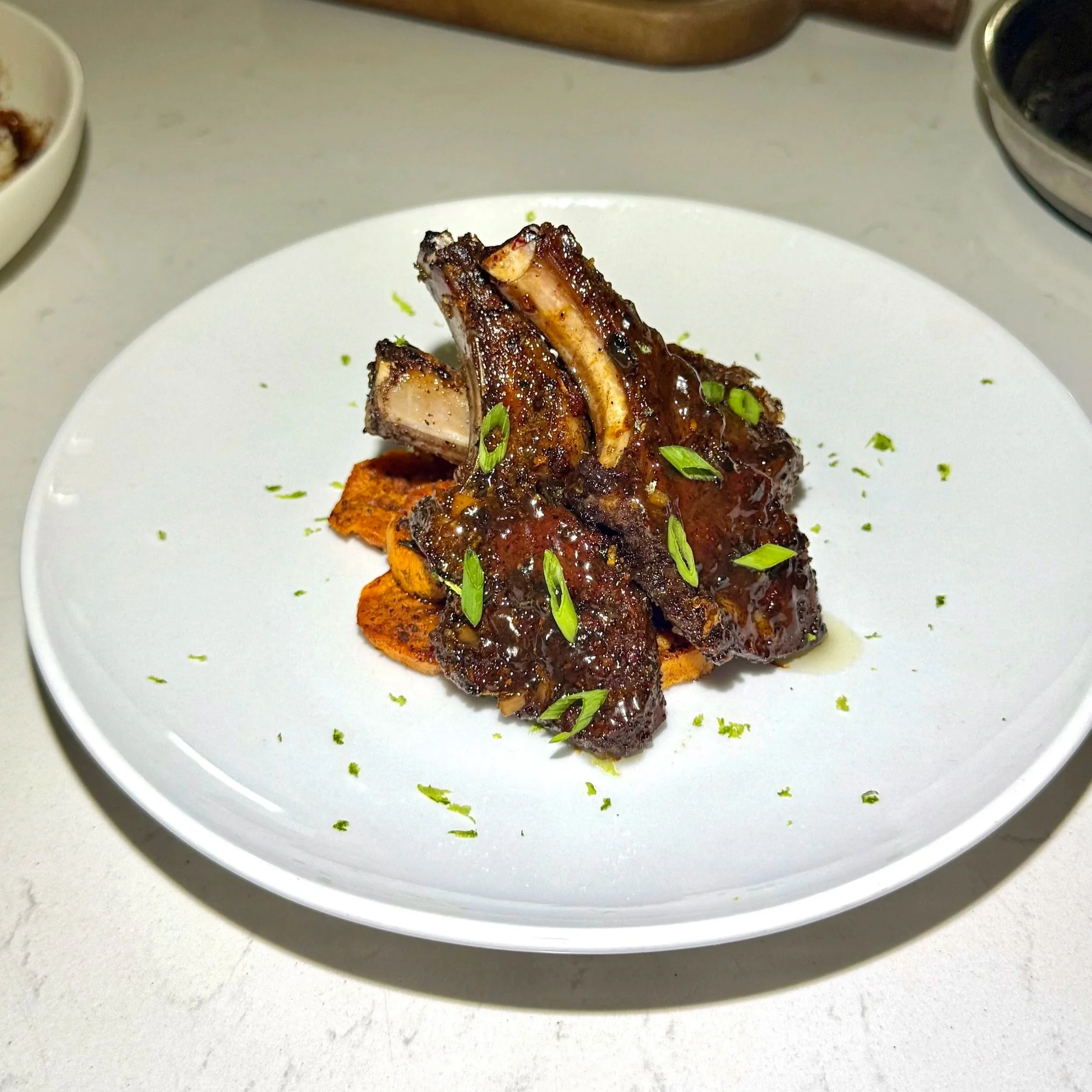  Plating the lamb chops with height for a fine‑dining presentation. 