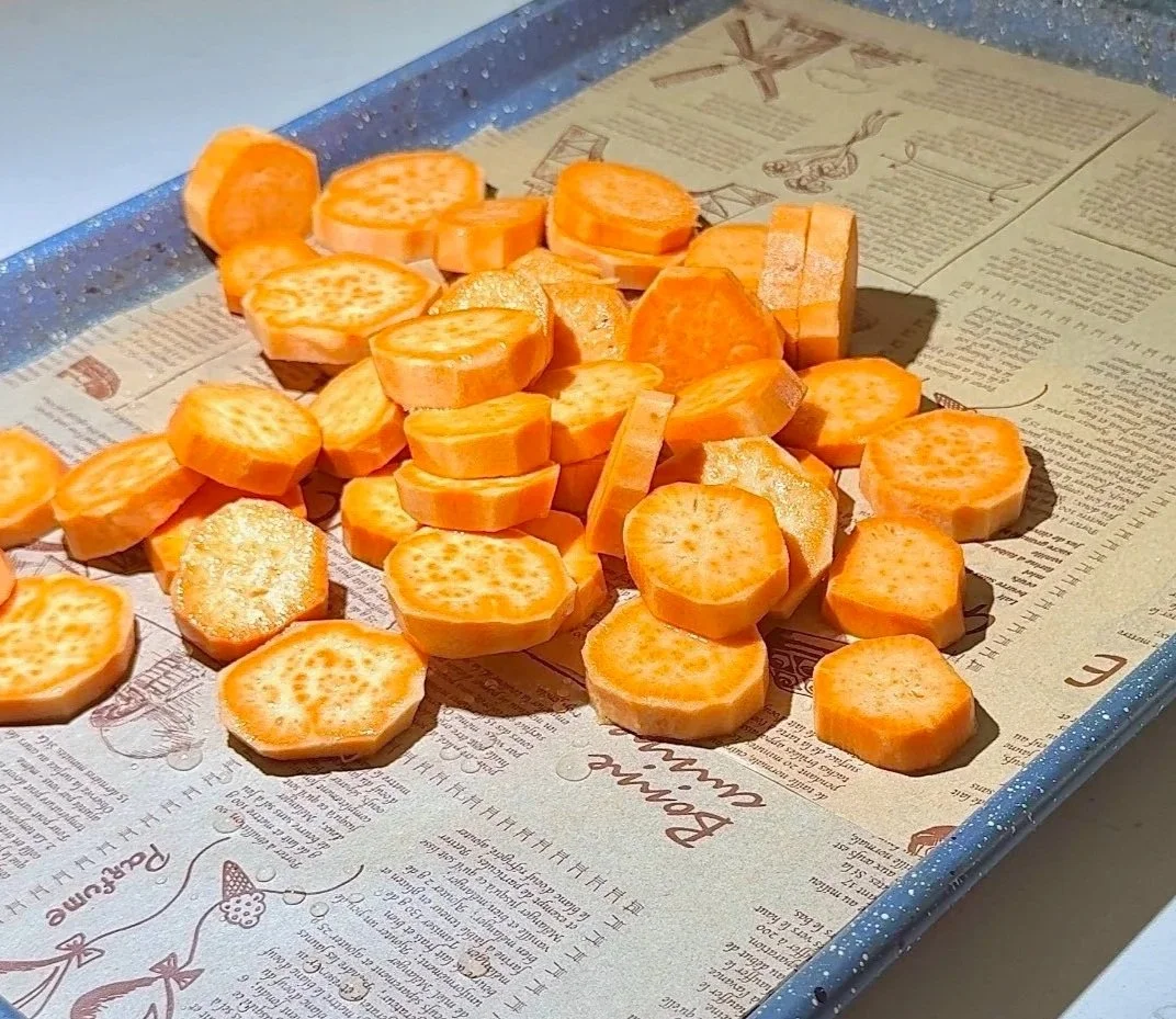  Slicing the sweet potatoes into rounds for even roasting. 
